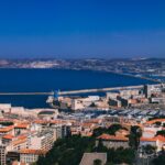 a city with a body of water in the background