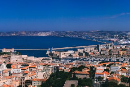 a city with a body of water in the background