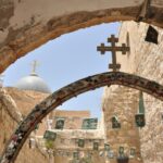 a church with a cross hanging from it's side