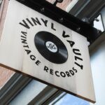 a sign hanging from the side of a building