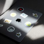 a laptop computer sitting on top of a gray couch