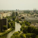 A river running through a city next to tall buildings