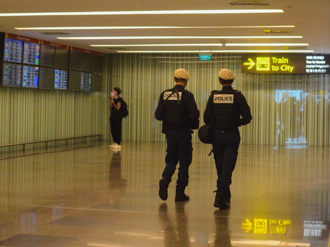Two police officers walking through an airport terminal