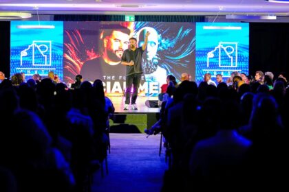 Speaker presenting on stage to an audience