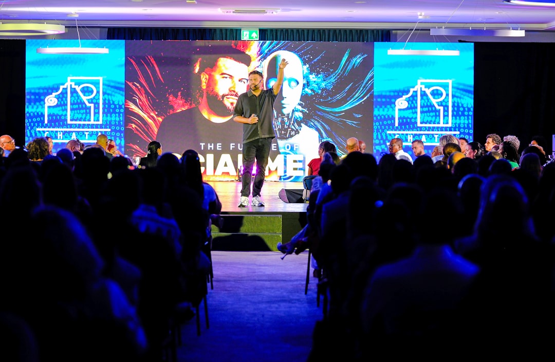 Speaker presenting on stage to an audience