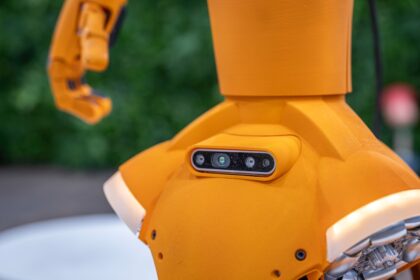 Close-up of an orange robot with a sensor array.