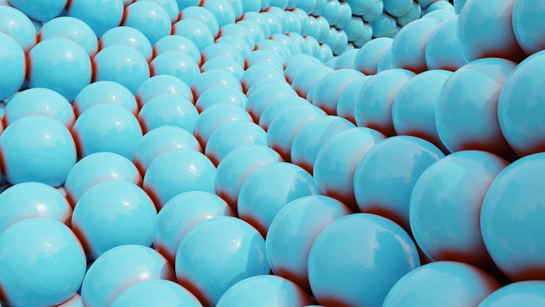Rows of light blue spheres form a spiral pattern.