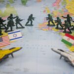 Toy soldiers and flags on world map
