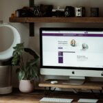 silver imac on brown wooden table