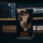 a book sitting on top of a table next to a radio