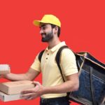 a man in a yellow hat holding a box
