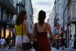 a couple of women walking down a street