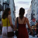 a couple of women walking down a street