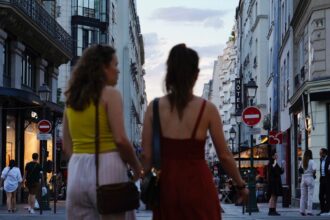 a couple of women walking down a street