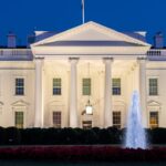 a white building with a fountain in front of it with White House in the background