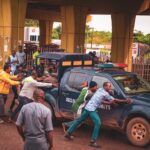 a group of people pushing a car