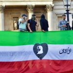 a group of people standing behind a banner