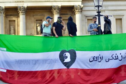 a group of people standing behind a banner
