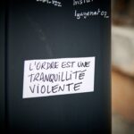 a black refrigerator with a white sticker on it