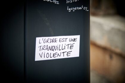 a black refrigerator with a white sticker on it