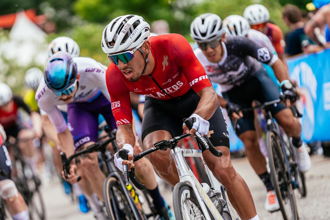 A group of men riding bikes down a road