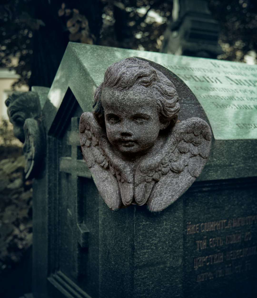 A statue of a little girl with angel wings on a grave