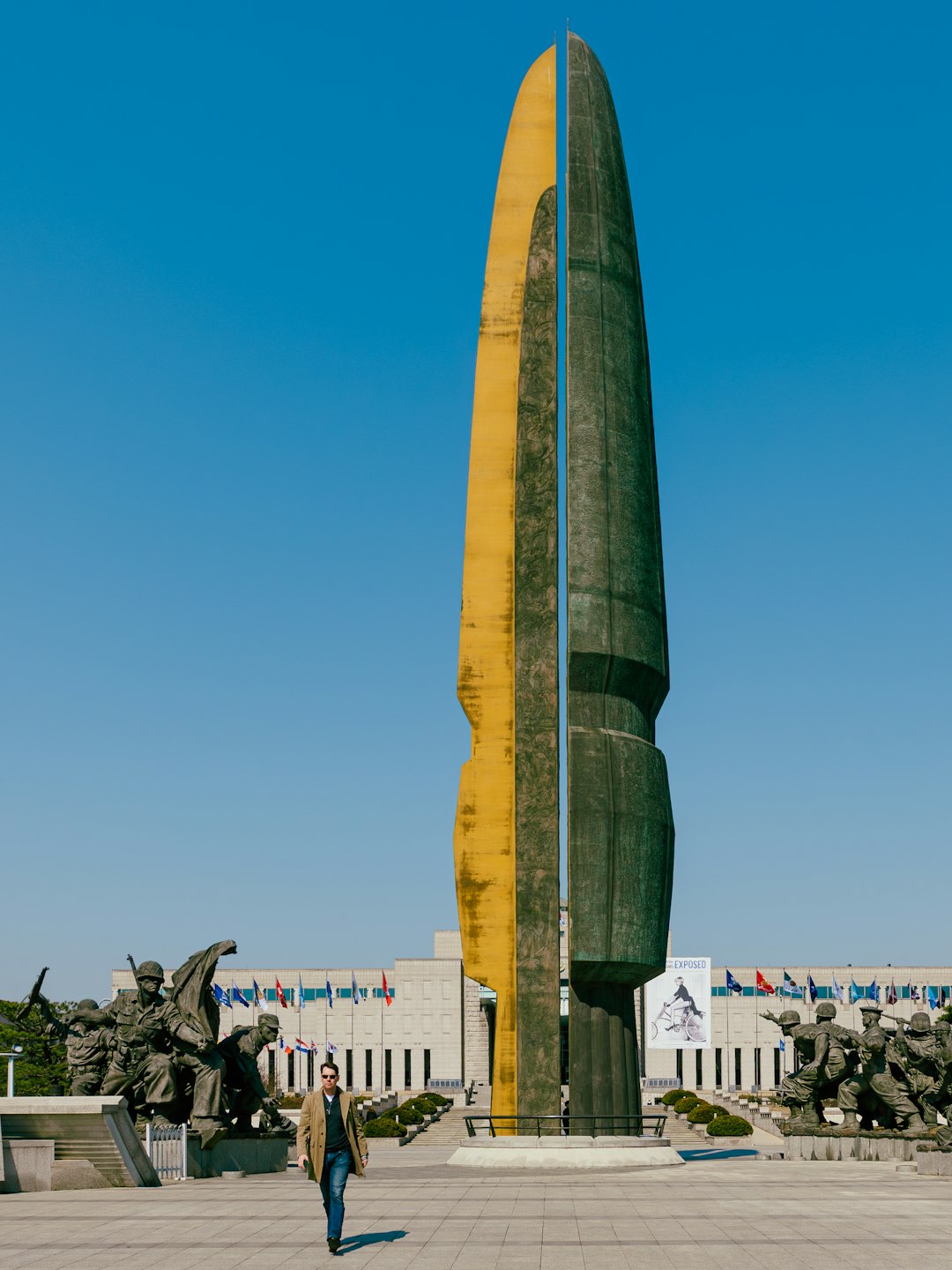 A man walks past a monumental sculpture.