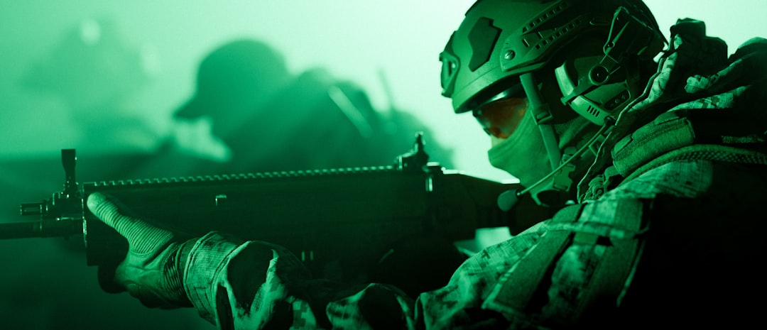 Soldier aiming rifle in green night vision