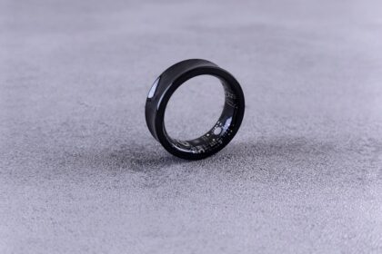 A black ring with white speckles on a gray surface