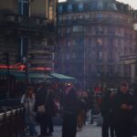 People walking on a street in paris at sunset