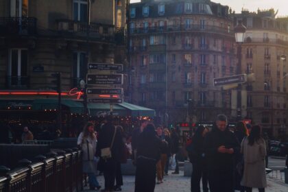 People walking on a street in paris at sunset