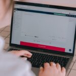 Person typing on a laptop computer screen