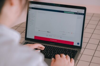 Person typing on a laptop computer screen
