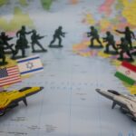 Toy soldiers and jets arranged on a world map.