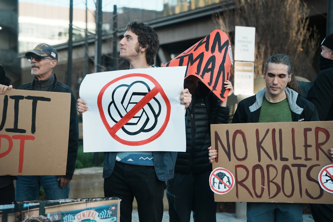 Protesters hold signs against ai and killer robots.