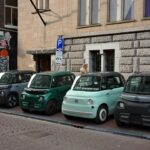 Several small cars parked in a row