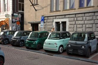 Several small cars parked in a row