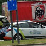 man in black jacket sitting on white car
