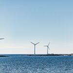 wind turbines on blue sea under blue sky during daytime