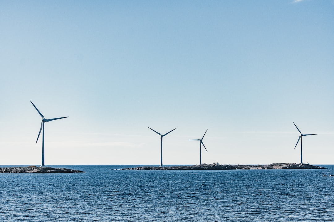 wind turbines on blue sea under blue sky during daytime