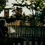 woman in black shirt sitting on bench