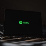 a laptop computer sitting on top of a bed