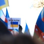 a group of people holding flags and signs