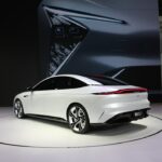 a white car is on display at a show