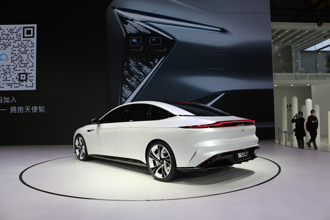 a white car is on display at a show