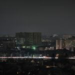 a city skyline at night with buildings lit up