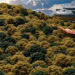 a large object flying over a lush green hillside