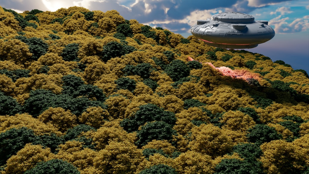 a large object flying over a lush green hillside