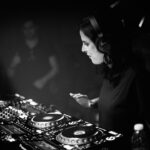 A dj mixing music in a dark room