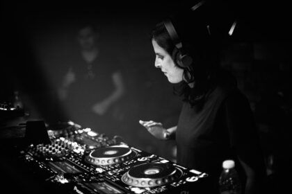 A dj mixing music in a dark room